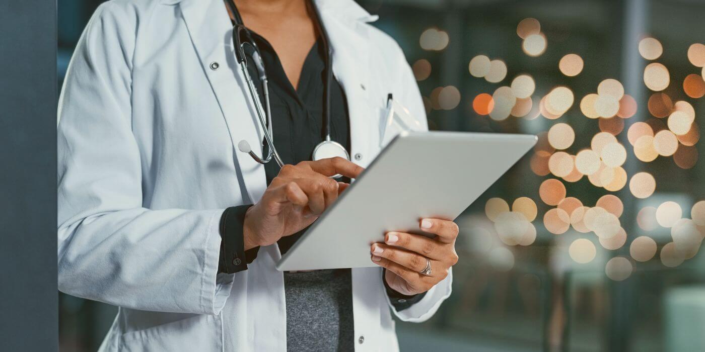 Healthcare professional using a tablet to support workplace violence prevention in healthcare