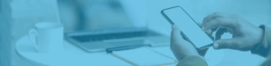 hand holding mobile smartphone laptop on desk in background T-Mobile Netherlands Resolver Case Study