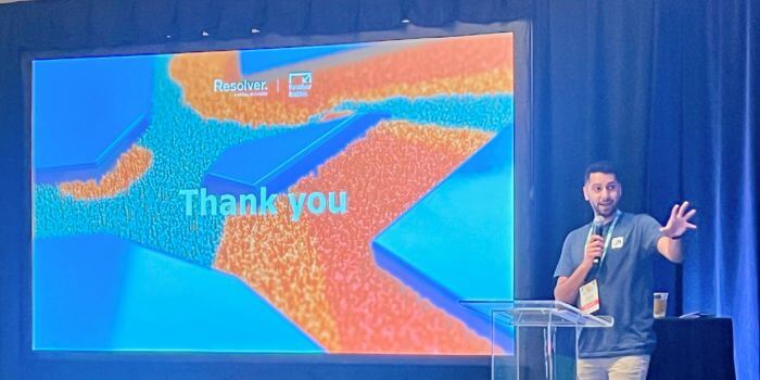 Riz shirazi presenting at ascend 2024 with a 'thank you' slide displayed on the screen behind him, showcasing resolver's branding.