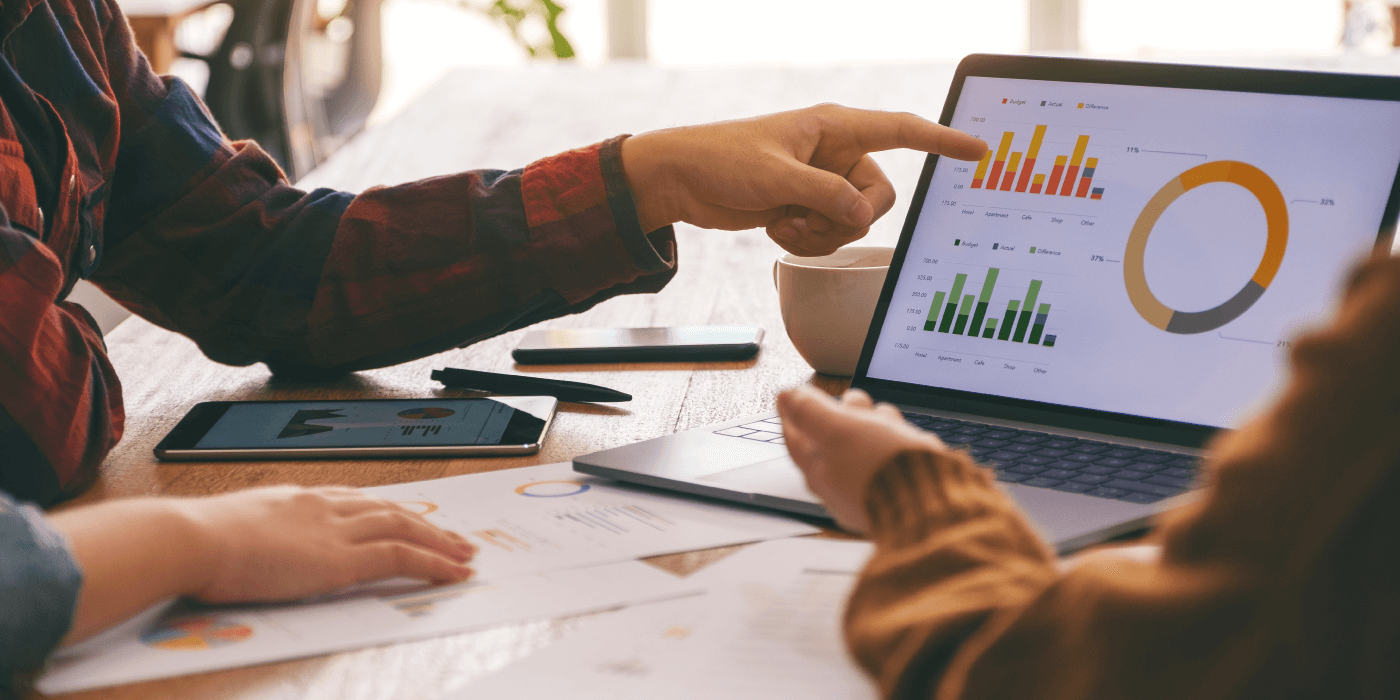 Professionals analyzing real-time performance metrics on a laptop.