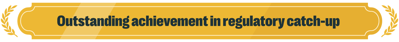 Top 5 #grcfails & the ai that's fixing them 2 Gold award-style banner with decorative laurel branches on both sides and a curved, ornamental frame. The background features layered shades of gold with subtle diagonal highlights, giving it a polished, dimensional look. Centered in bold, dark teal text reads: “outstanding achievement in regulatory catch-up. ” the overall design resembles a formal recognition badge or achievement ribbon, conveying accomplishment and prestige.